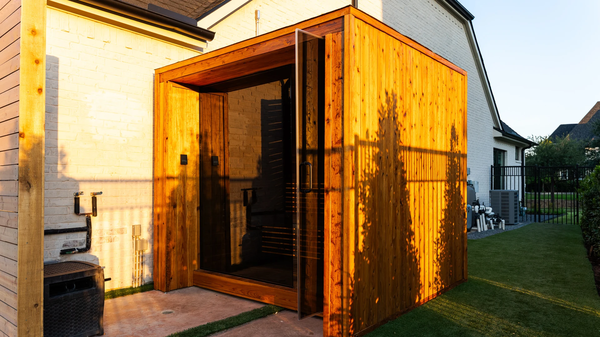 Light rays streaming through LED-backlit slat backrest onto cedar walls