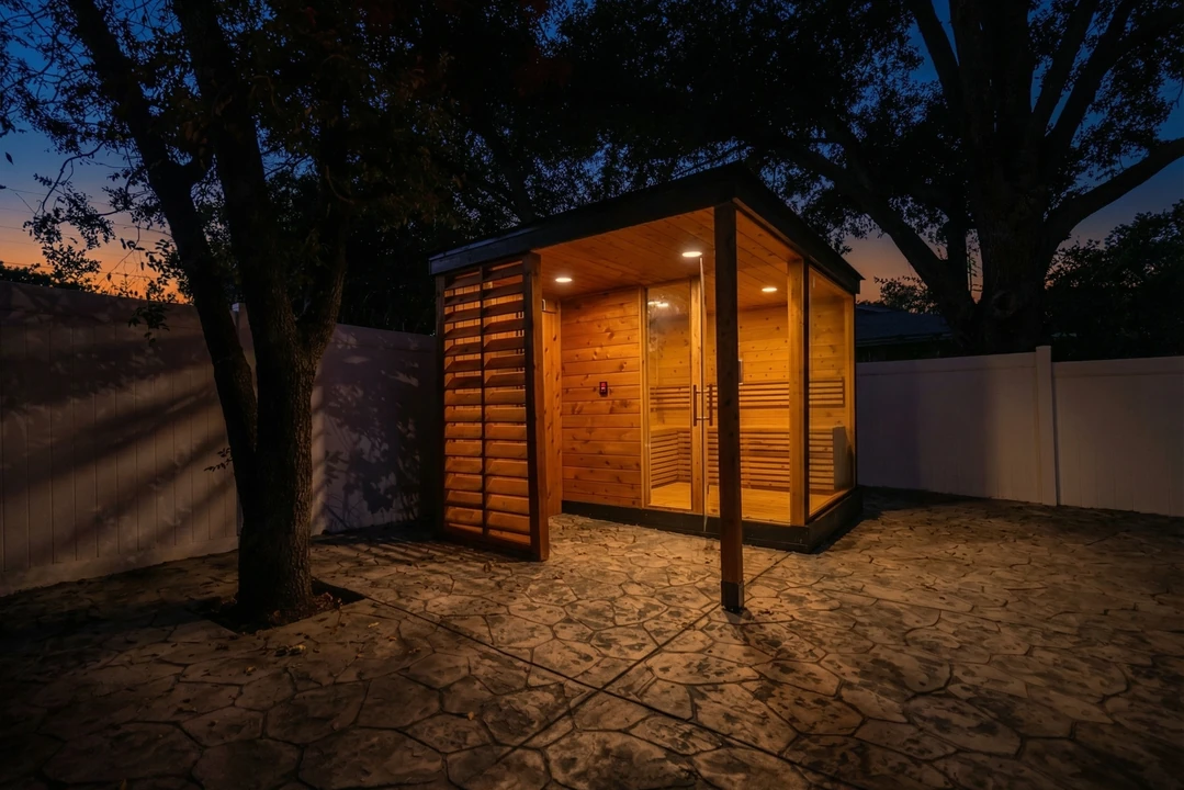 Backyard sauna on stamped concrete patio — evening twilight shot