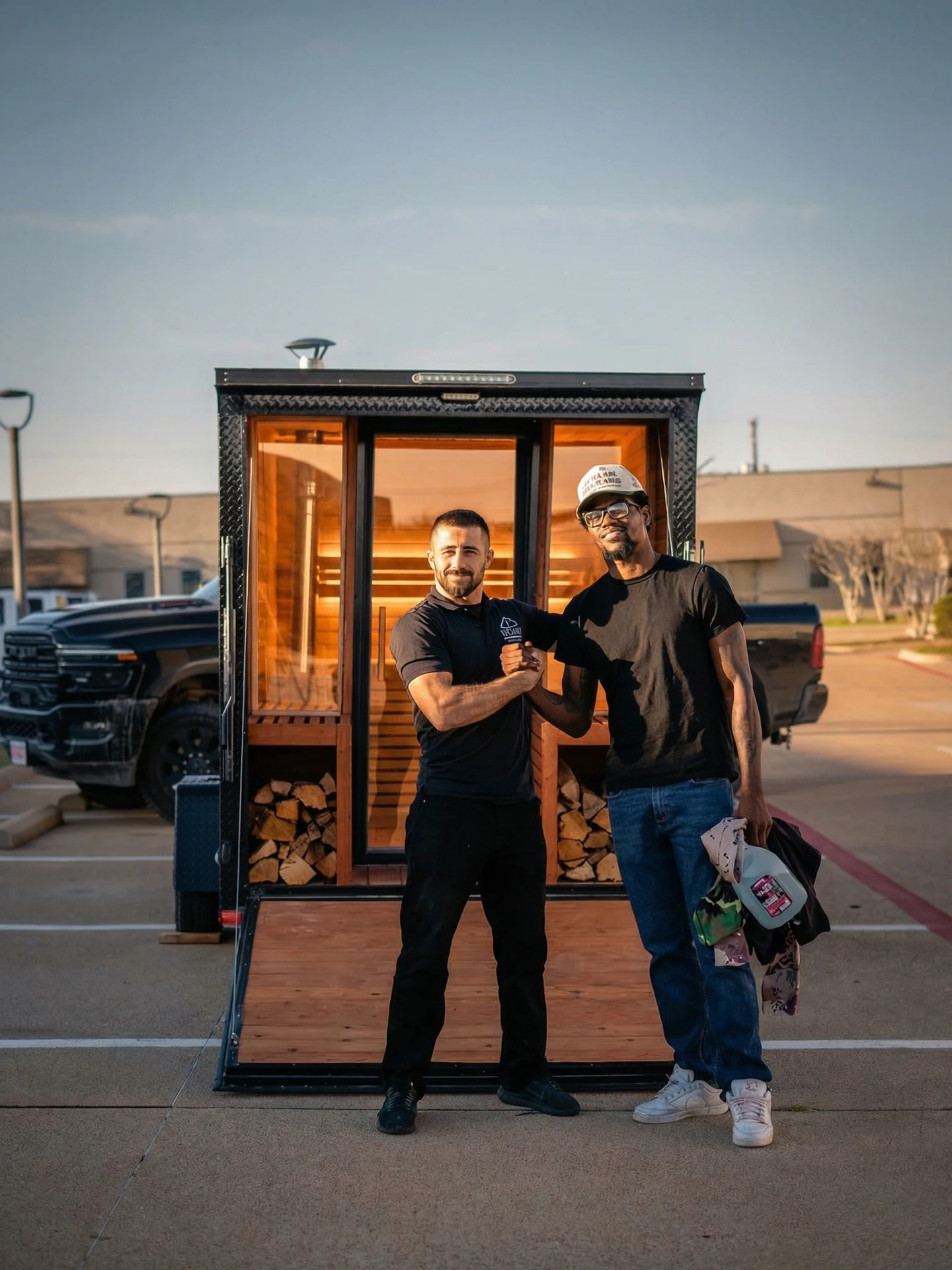 Abbas Mounshed and Kevin Holland in front of the custom mobile sauna trailer
